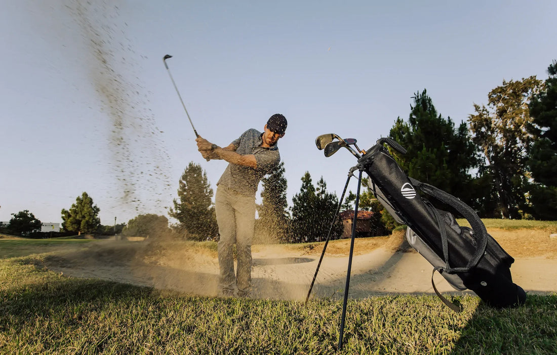 man golfing in sand