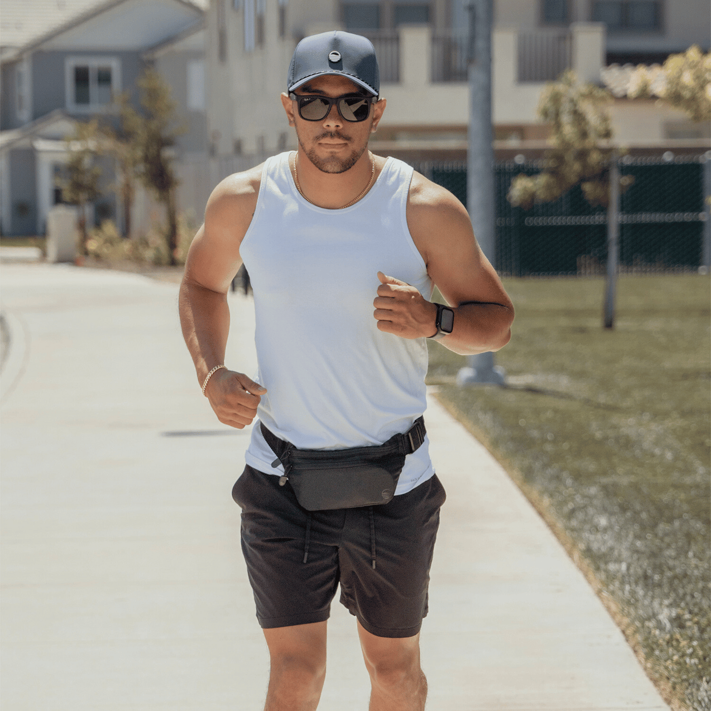 Black Runner Sling worn by a man running, paired with a navy Porter Lite hat.