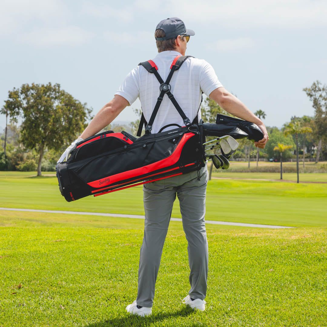 Man carrying ryder blackjack golf bag on a golf course