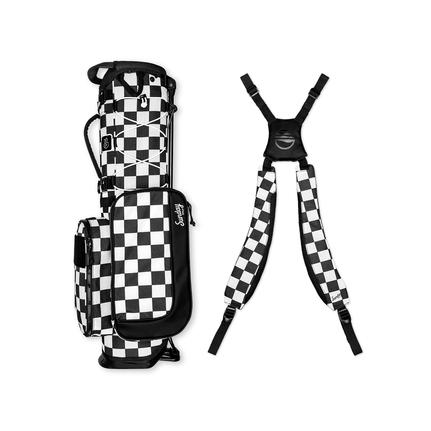 A full shot of a checkered Black & White Recess kids golf bag laying flat sideways beside its double straps