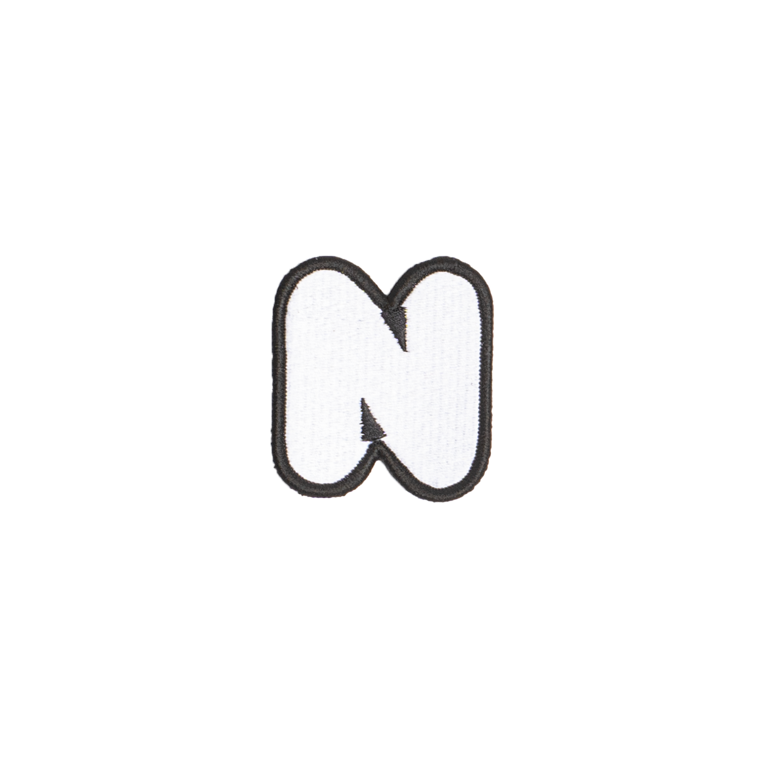 A white embroidered letter 'N' patch with a black border