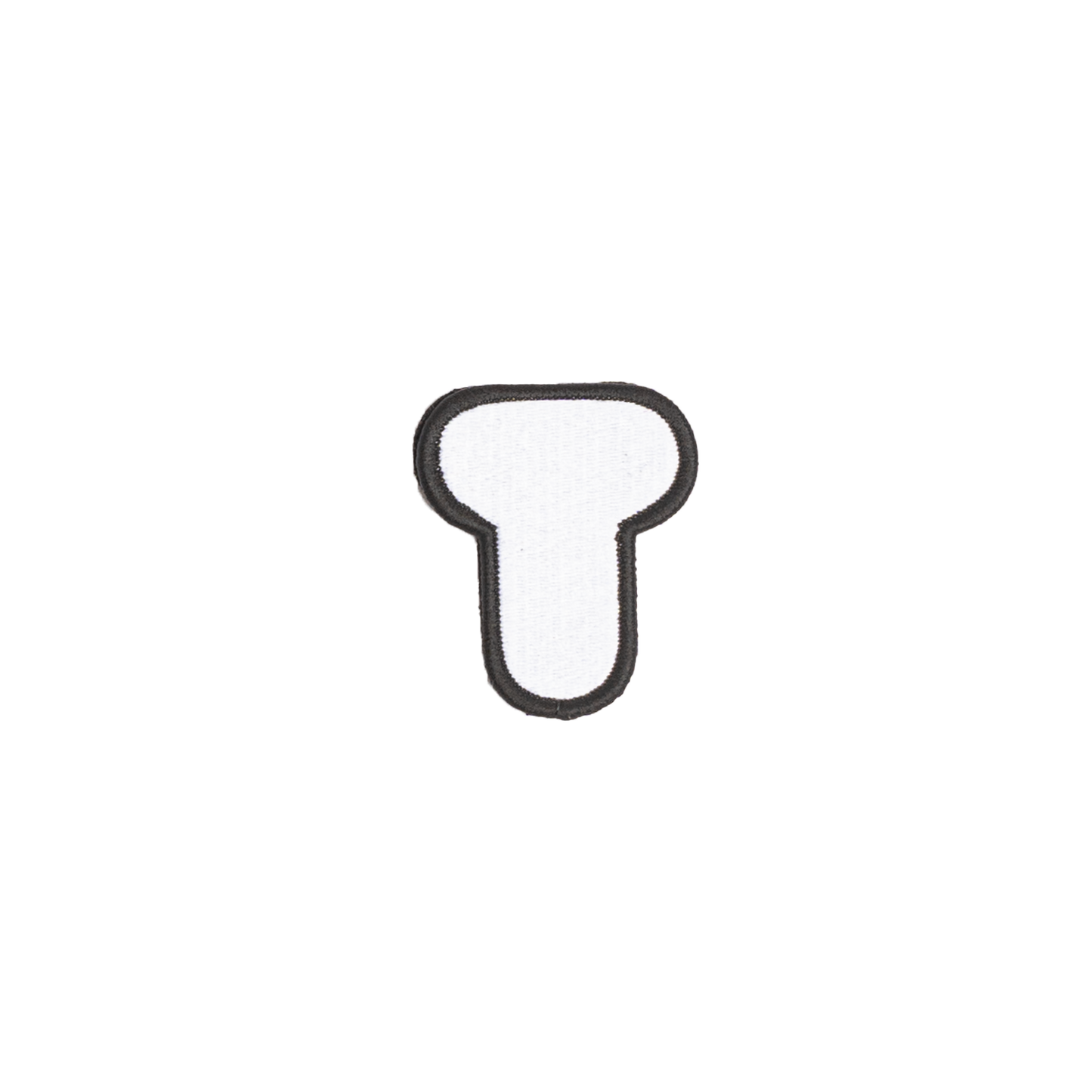 A white embroidered letter 'T' patch with a black border
