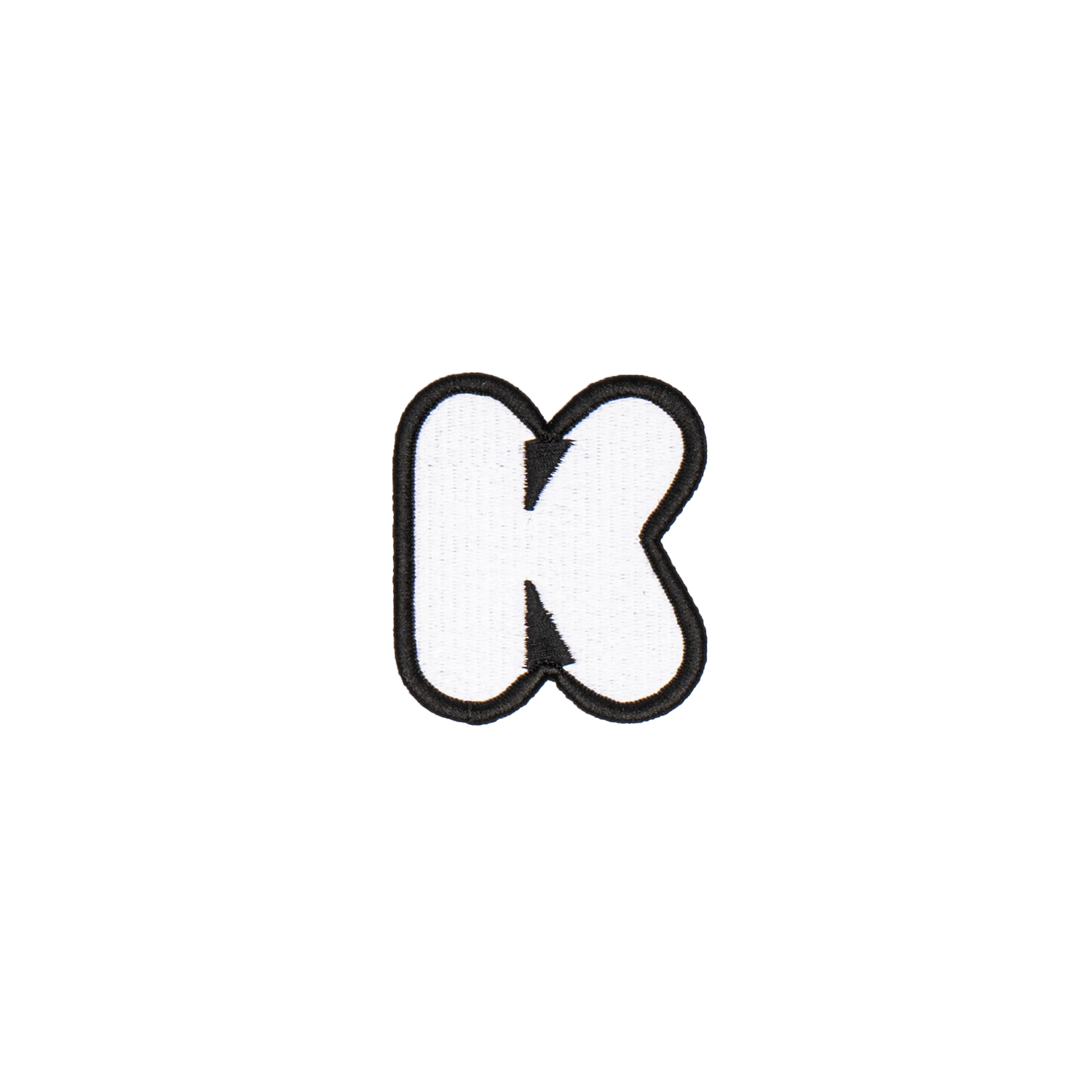 A white embroidered letter 'K' patch with a black border