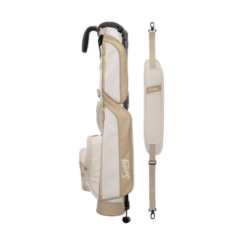 A full shot of Loma golf bag in toasted almond laying flat sideways beside its single strap