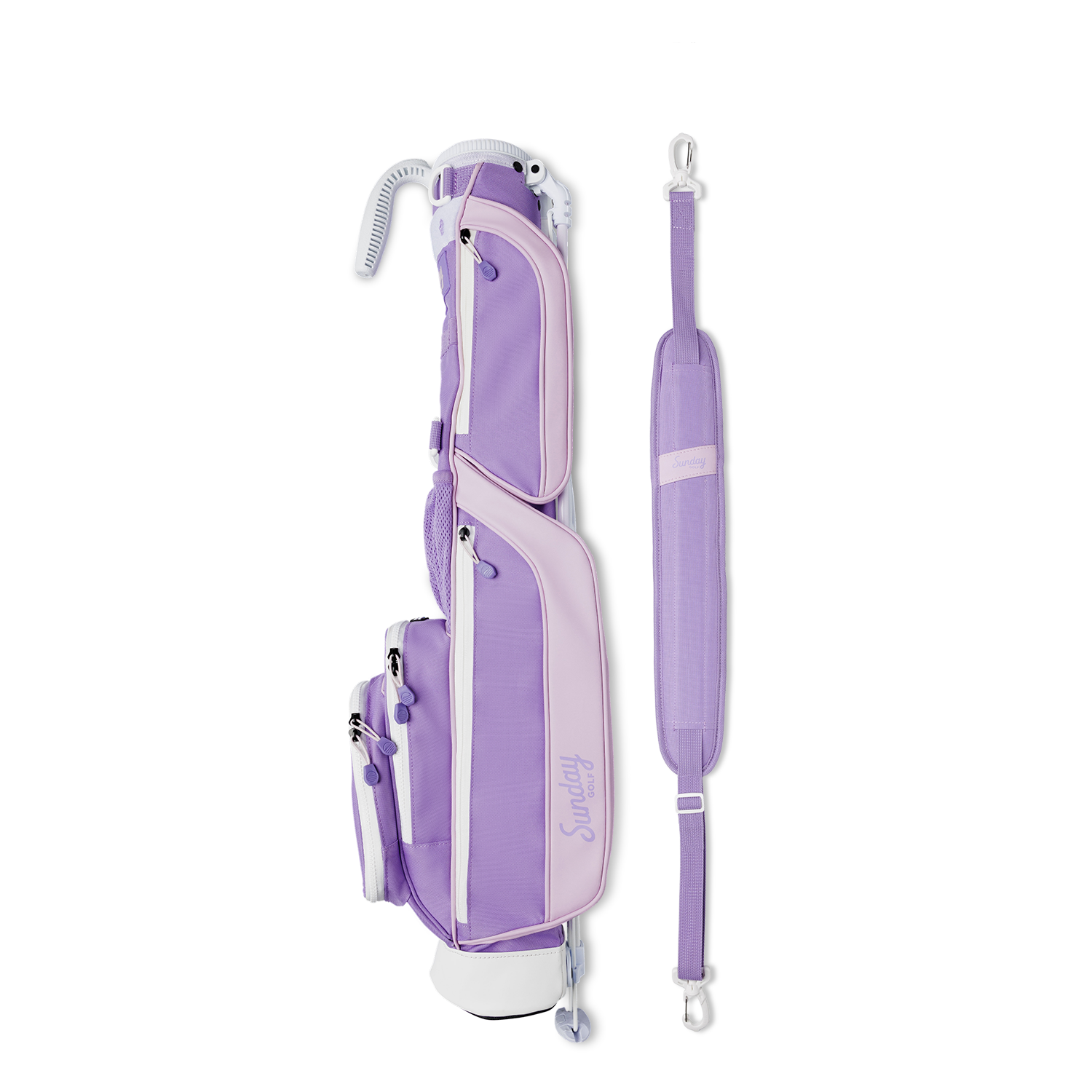 A full shot of Loma golf bag in lavender laying flat sideways beside its single strap