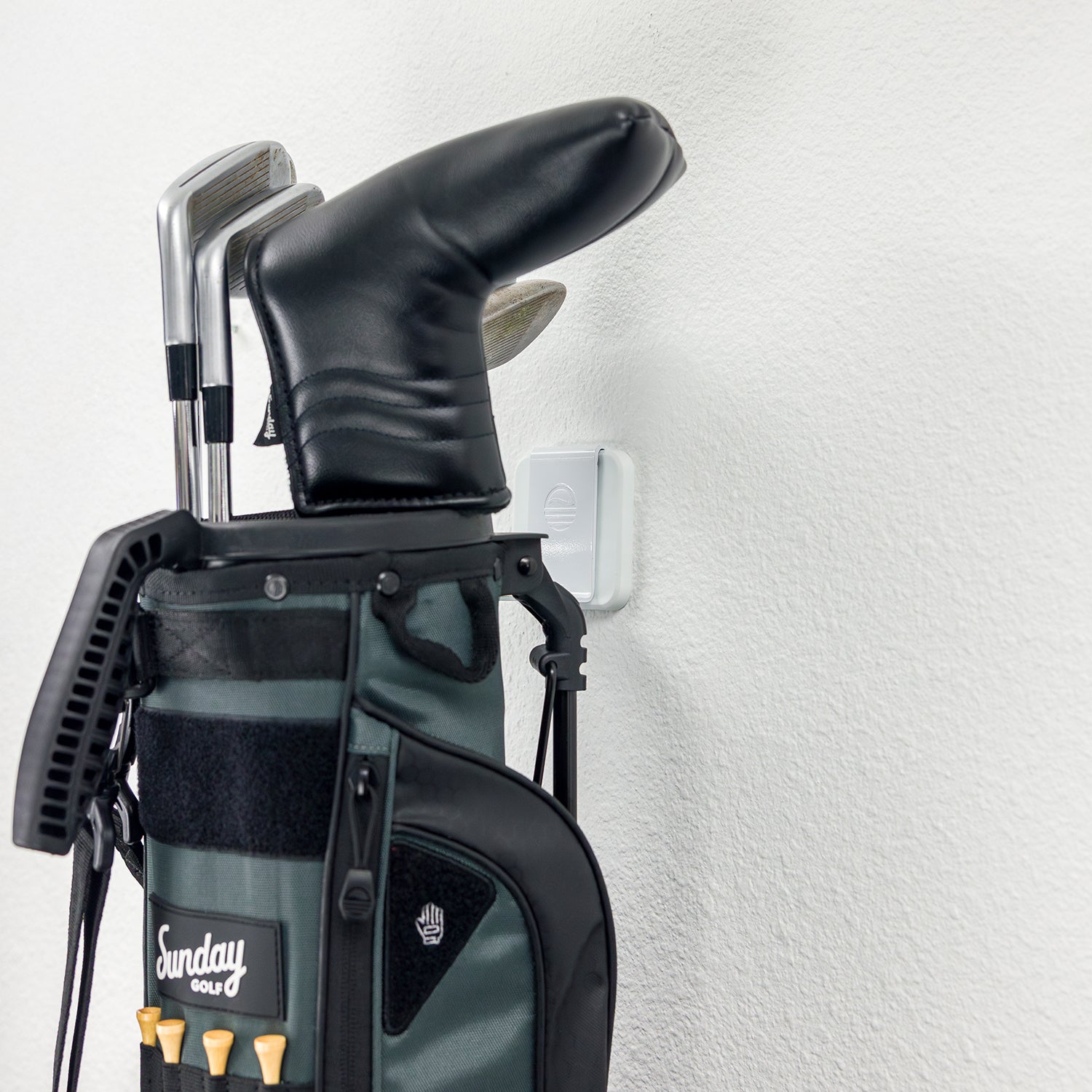 A white Loma Wall hook wall-mounted with a Loma bag