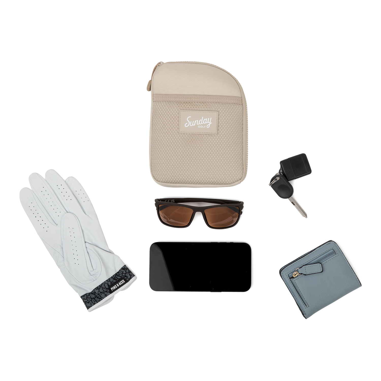 Toasted almond nickel bag valuables pouch laying flat with items it can hold