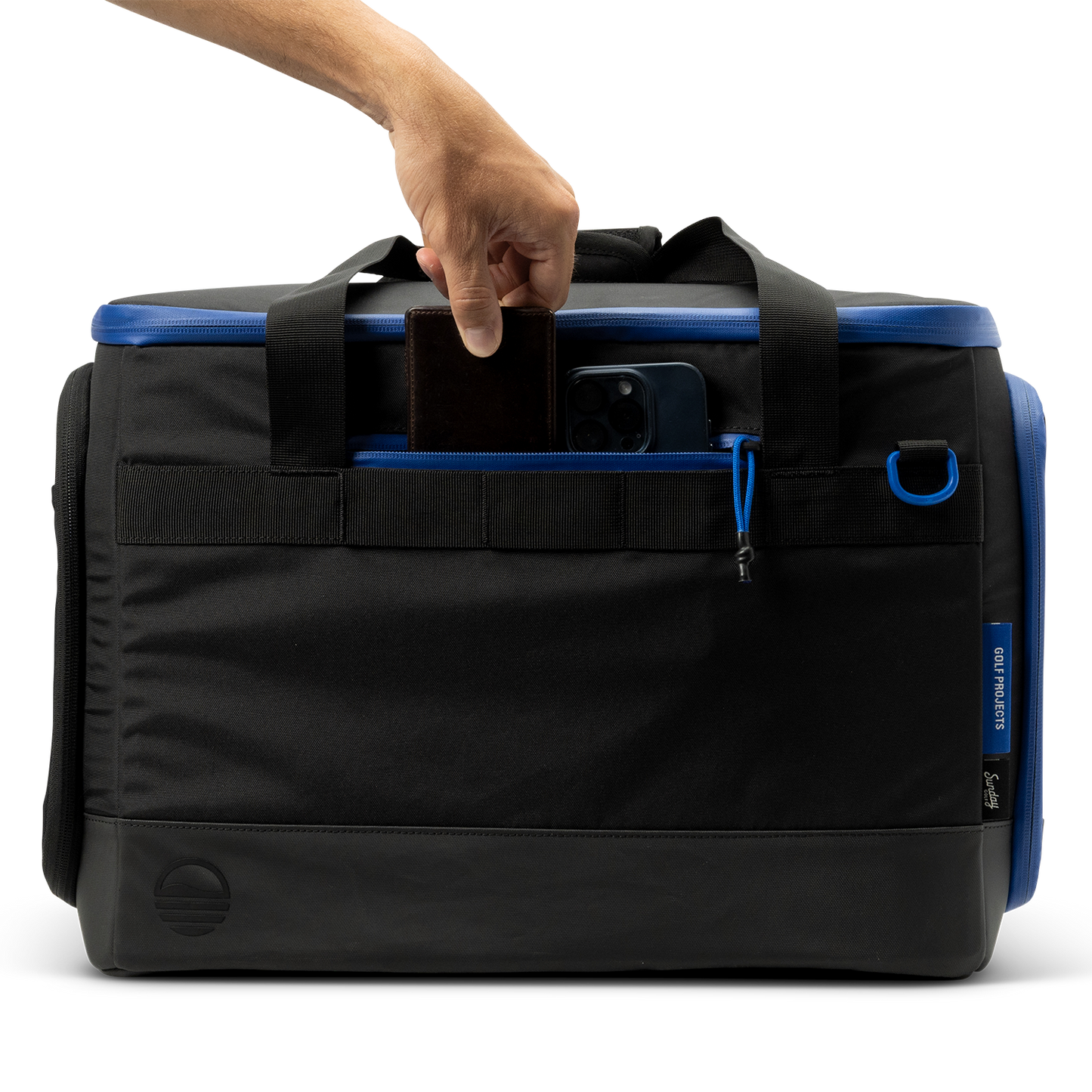 Sunday Golf's Creator Duffle Bag Blue with a hand gripping the handle