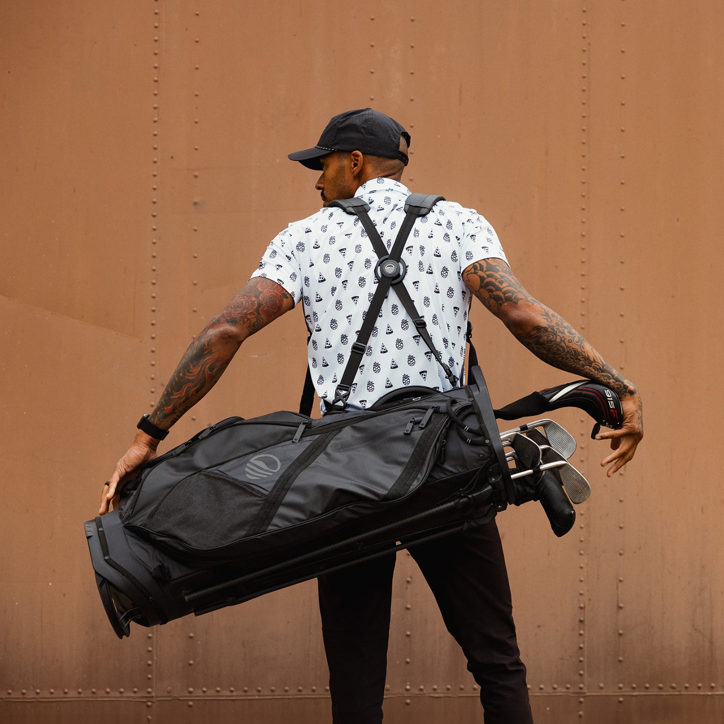 A man carrying The Ranger golf bag on his back