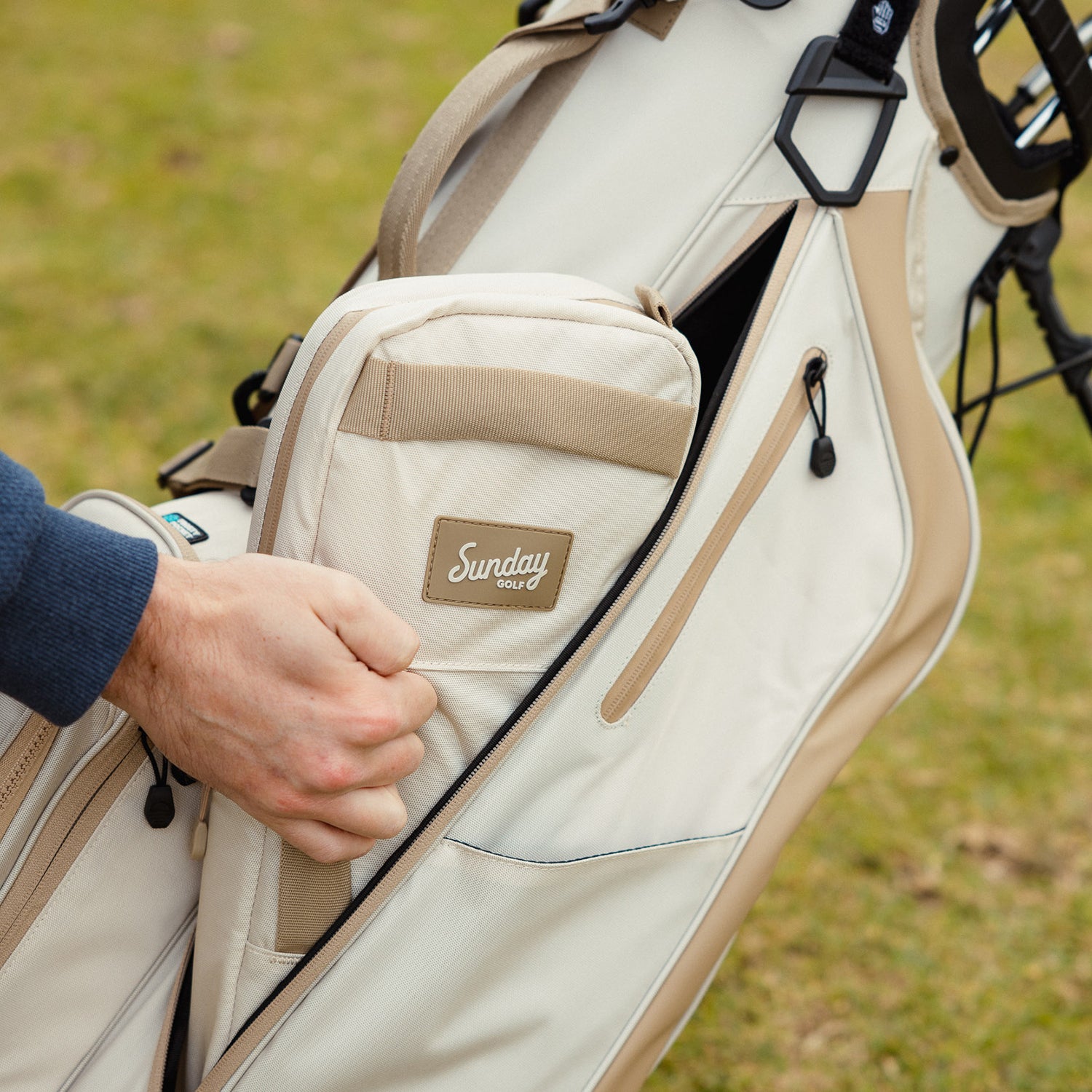 Big frosty golf cooler bag in toasted almond being placed inside a toasted almond golf bag