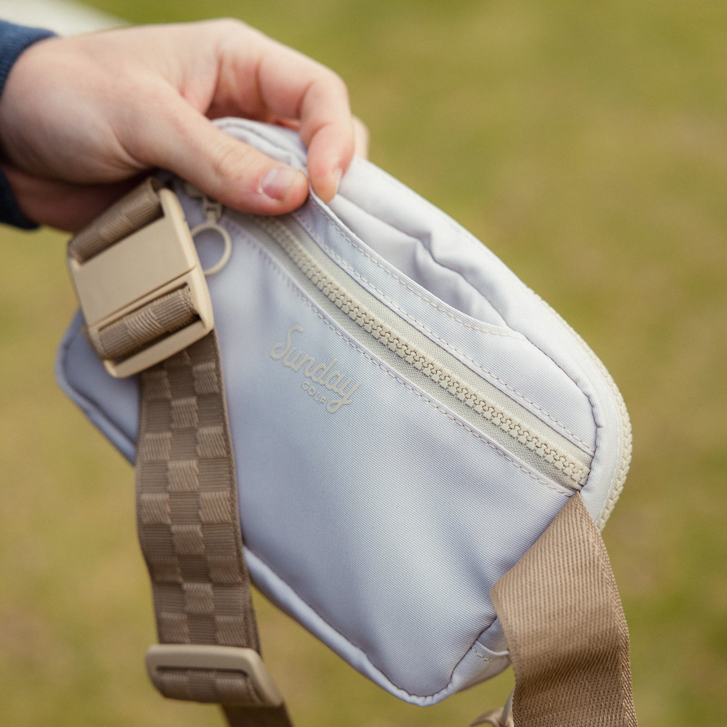 A close up shot of toasted almond belt bag