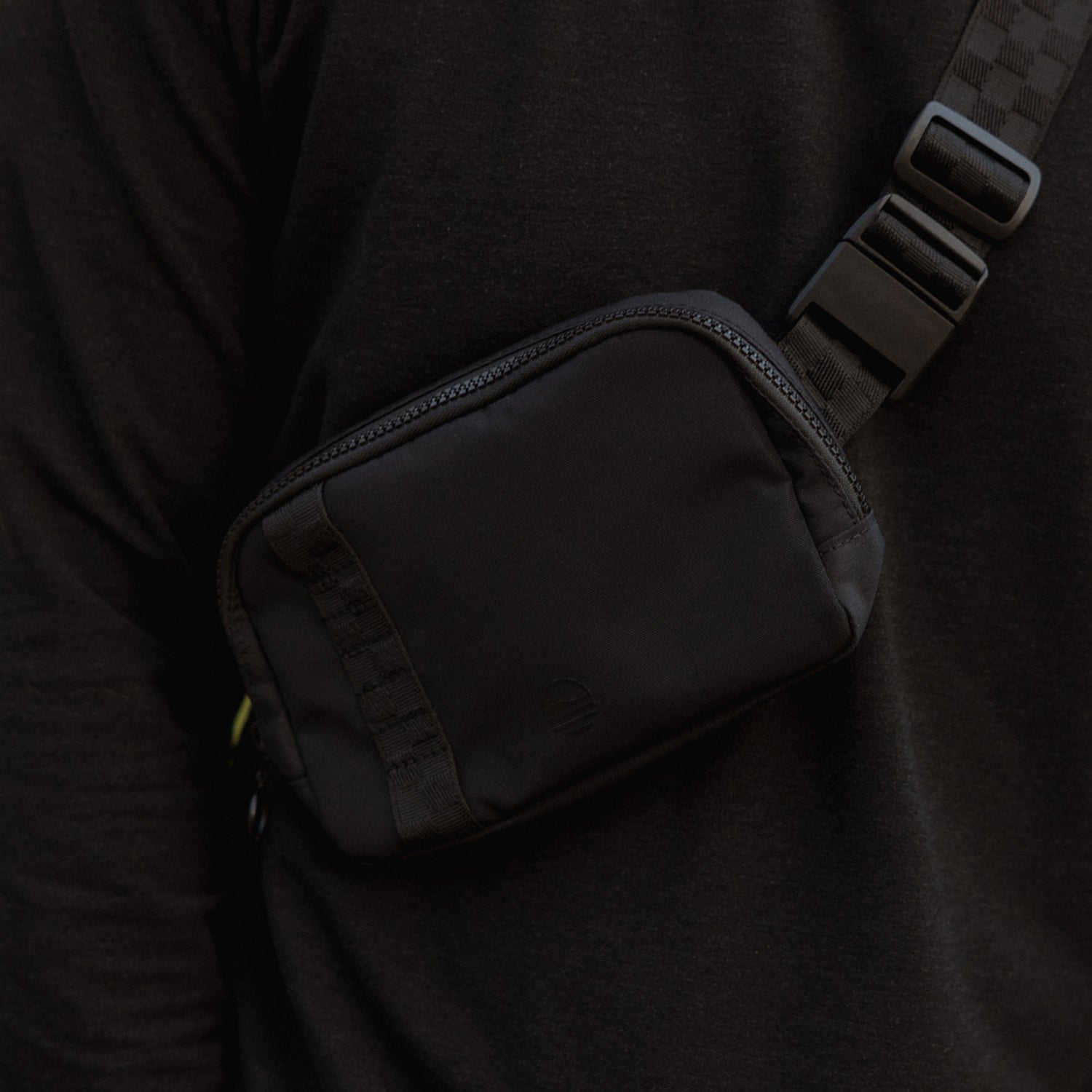 Close up shot of women's belt bag in black when worn