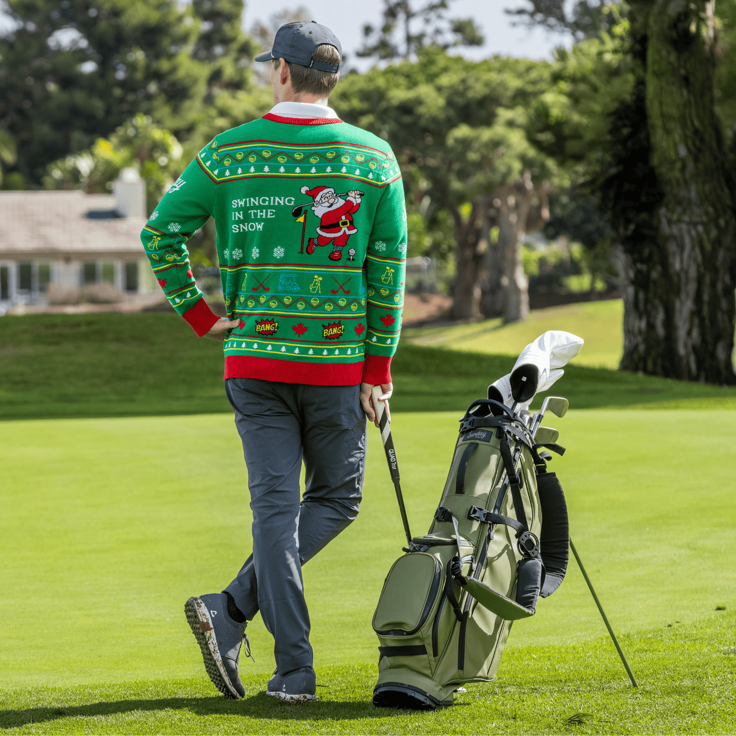 Man wearing the Ugly Sweater walking with a golf bag on a golf course