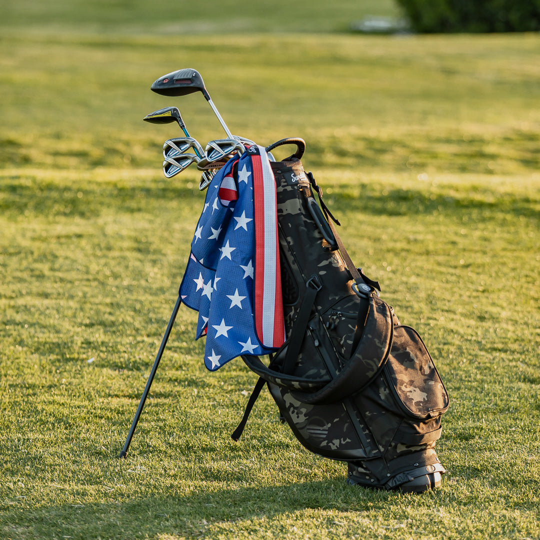 red white and blue golf towel on el camino golf bag at golf course