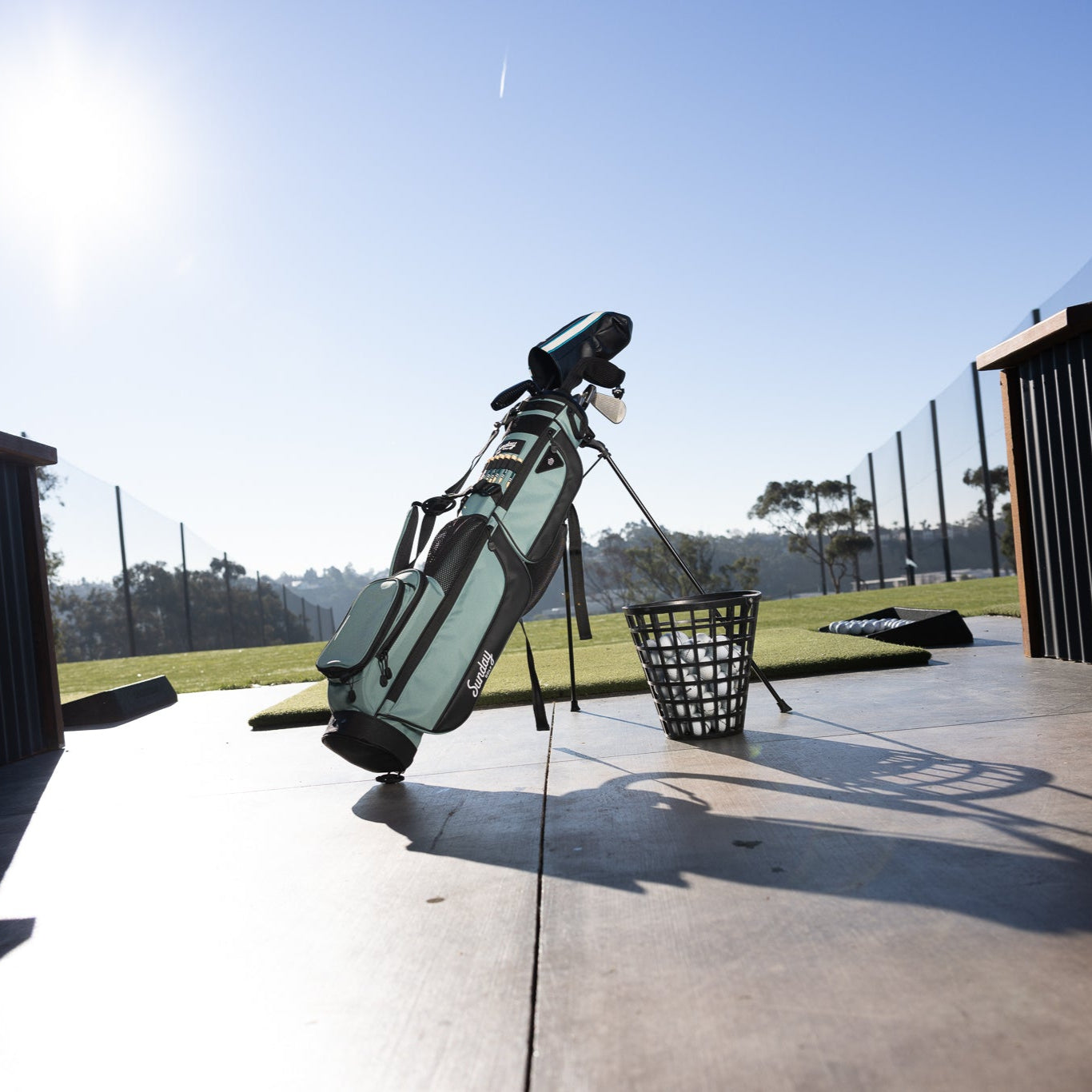 A standing seafoam Loma XL golf bag at the driving range