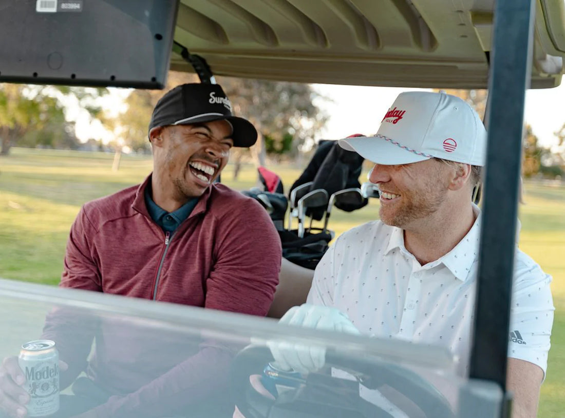 men laughing in golf cart
