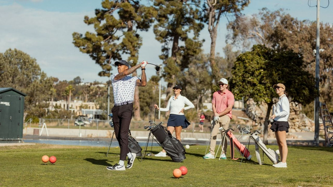 Four people playing golf with Sunday Golf golf bags in the background