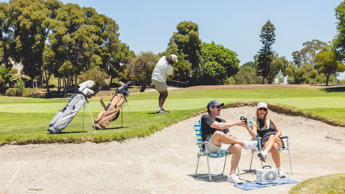 Three people seen in the golf course with their Sunday Golf golf bags in the background