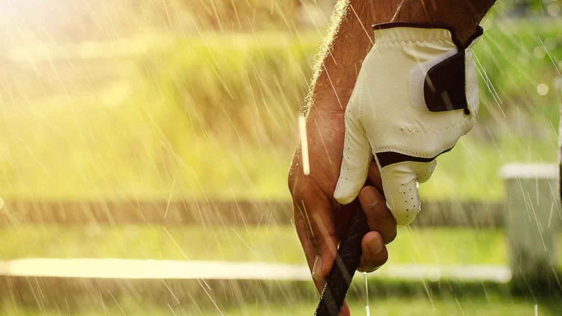 Hand wearing Sunday Golf gloves while playing golf in a rainy background
