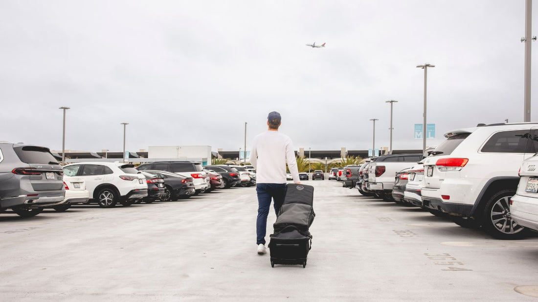 A man pulling his Sunday Golf golf bag in a parking lot