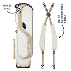 A full shot of El Camino golf bag in toasted almond laying flat sideways beside its double strap with product description labels