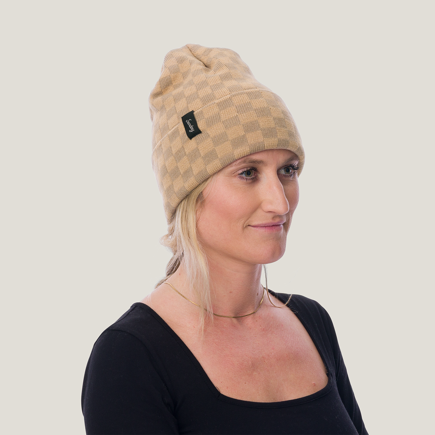 Woman wearing the checkered mickey beanie