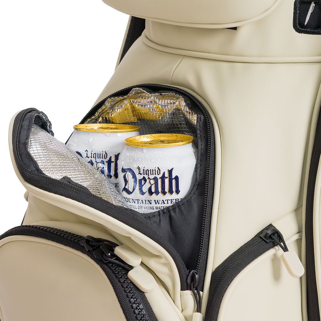 A close up shot of Cream Big Rig S-class golf bag's frosty pocket with canned drinks inside
