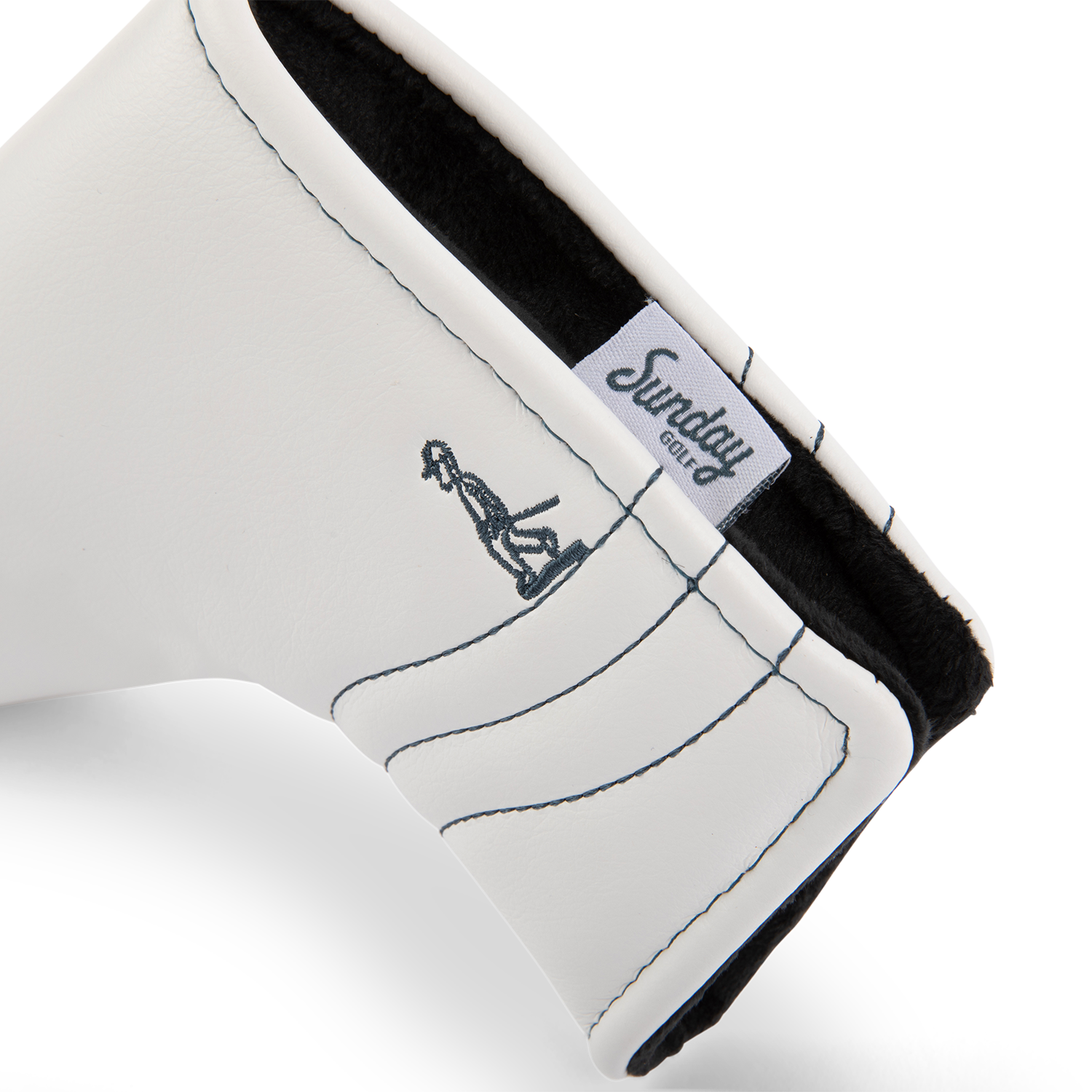 Inward shot of blade putter golf headcover in white/navy vegan leather
