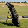 A full shot of standing El Camino S-Class golf bag in black vegan leather material on course with its double strap attached