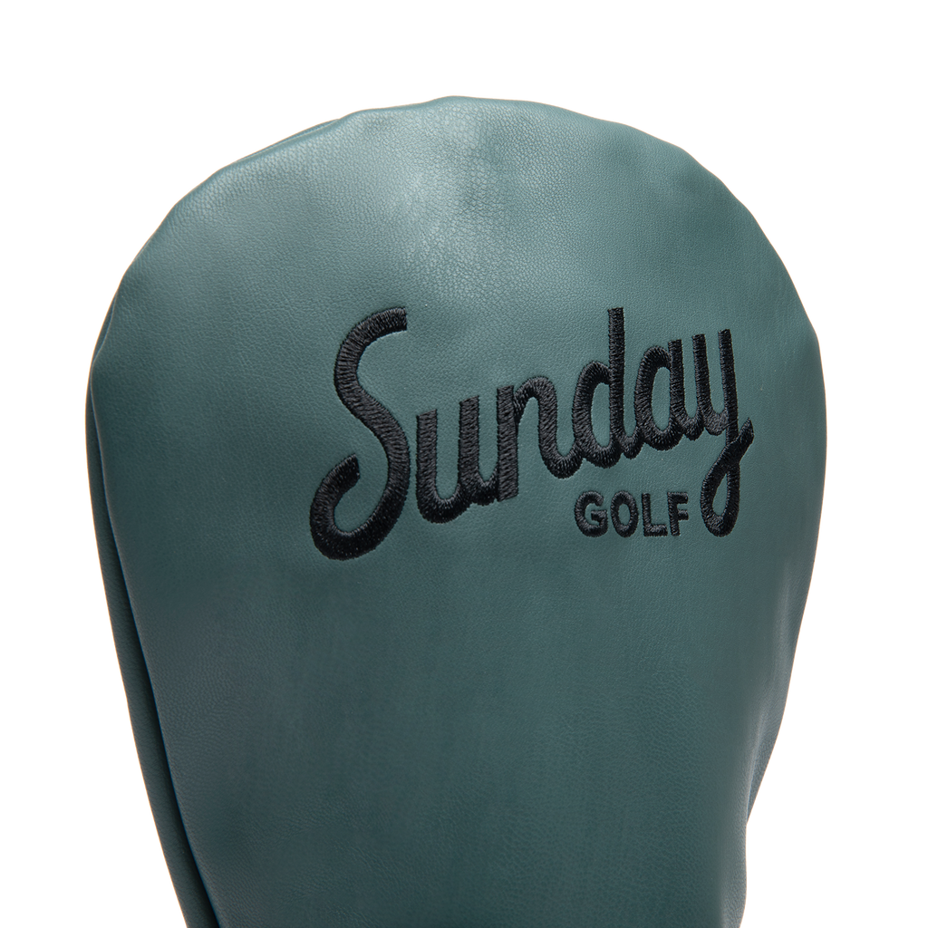 Close up shot of driver golf headcover in midnight green vegan leather showing its material and Sunday Golf logo

