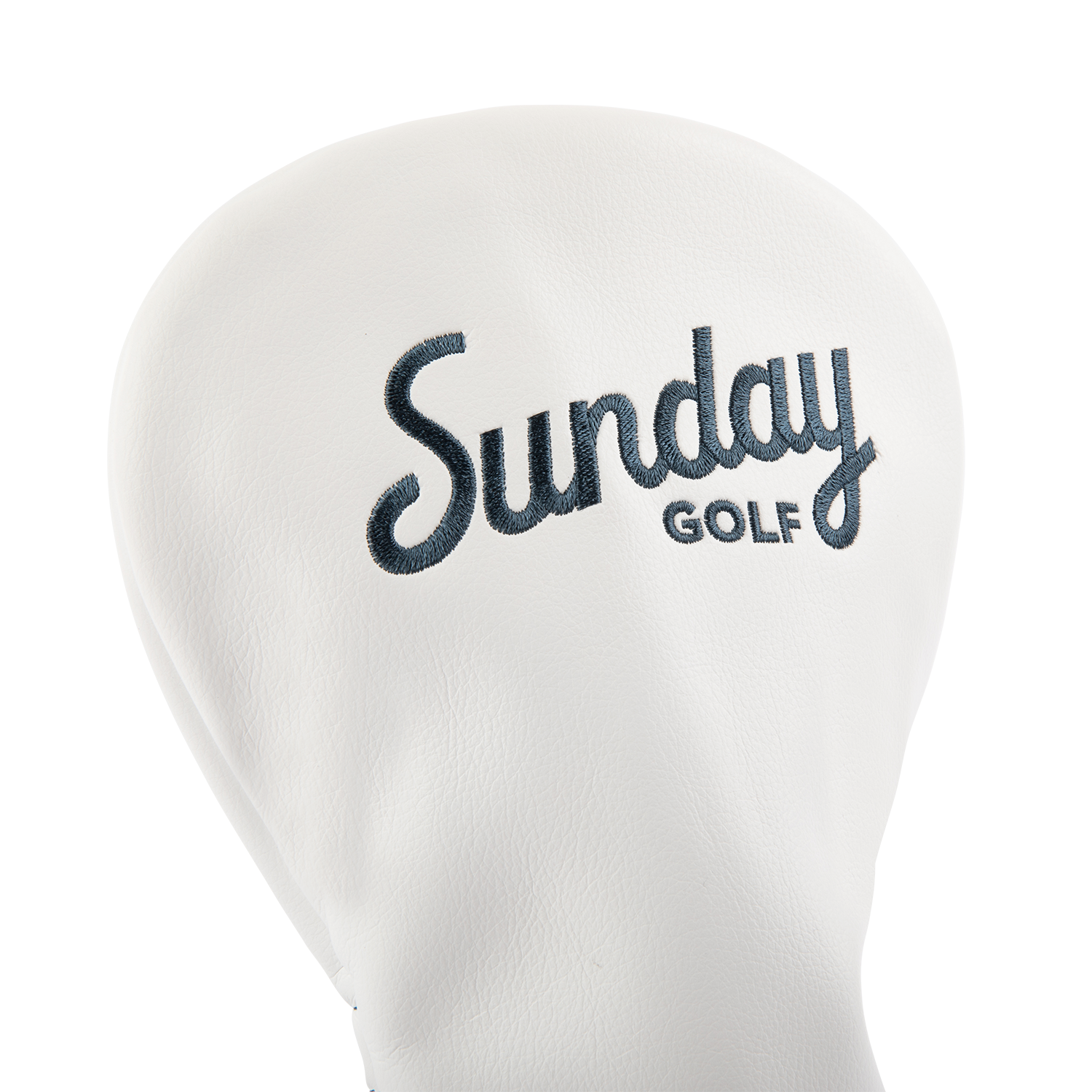 Close up shot of driver golf headcover in white and navy vegan leather showing its material and Sunday Golf logo
