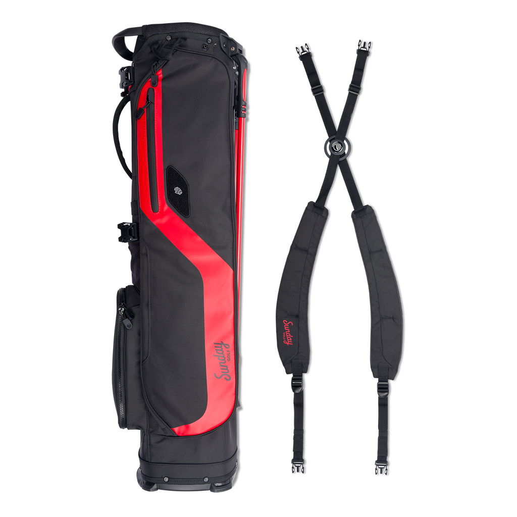 A full shot of El Camino golf bag in blackjack laying flat sideways beside its double strap 
