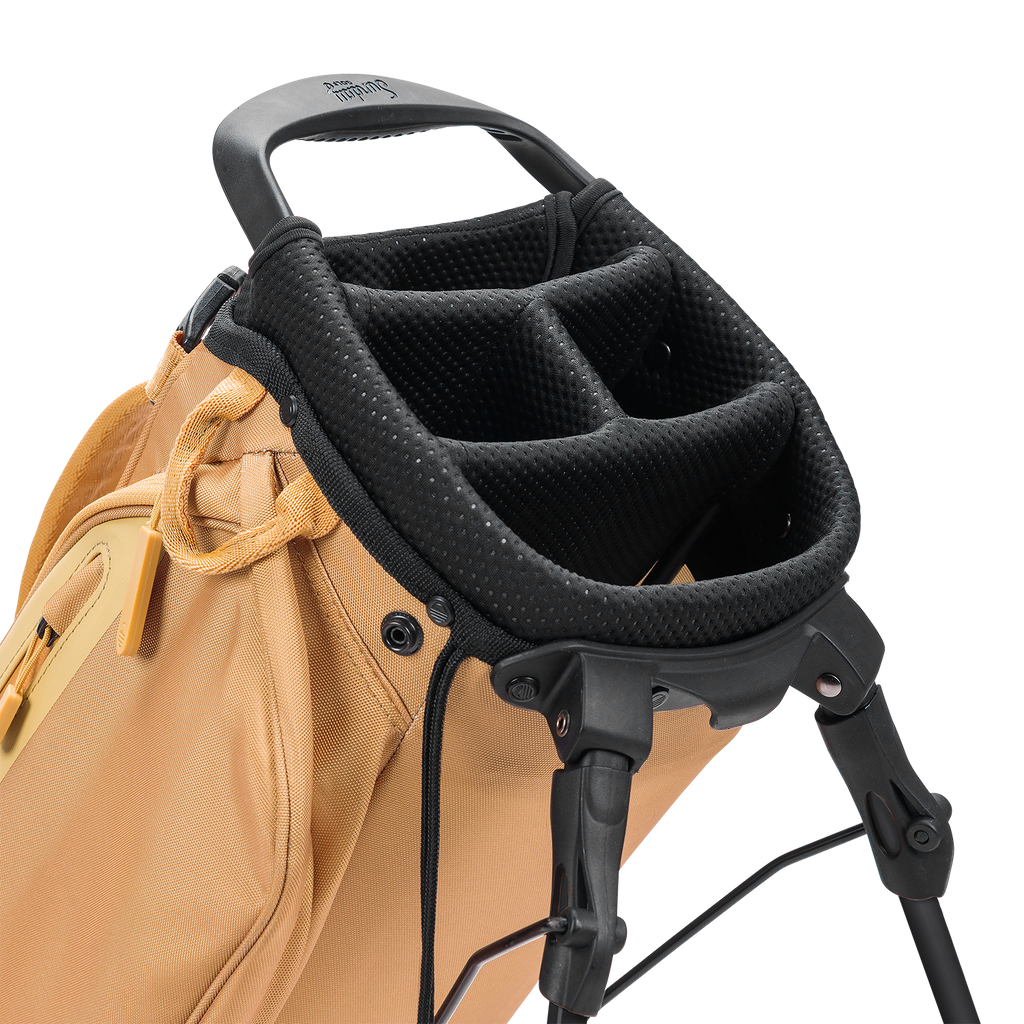 Close-up of a golf bag with a black stand and handle on a white background