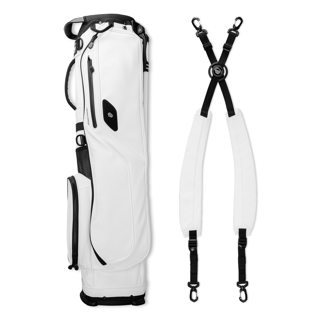 El Camino S-Class golf bag in white vegan leather laying sideways flat beside a double strap
