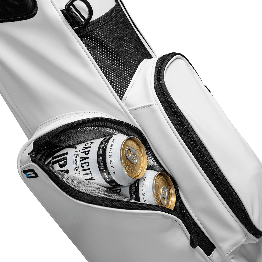 A close up shot of El Camino S-Class golf bag in white vegan leather showing off its frosty pocket with canned drinks inside