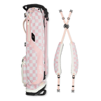 A full shot of El Camino golf bag in Pink/White Checker laying flat sideways beside its double strap 
