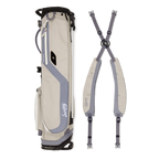 A full shot of El Camino golf bag in Cool Gray laying flat sideways beside its double strap 
