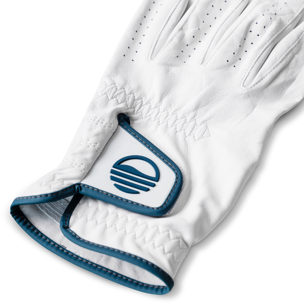 Close up shot of leather golf glove in navy and white color showing its velcro closure with Sunday Golf logo