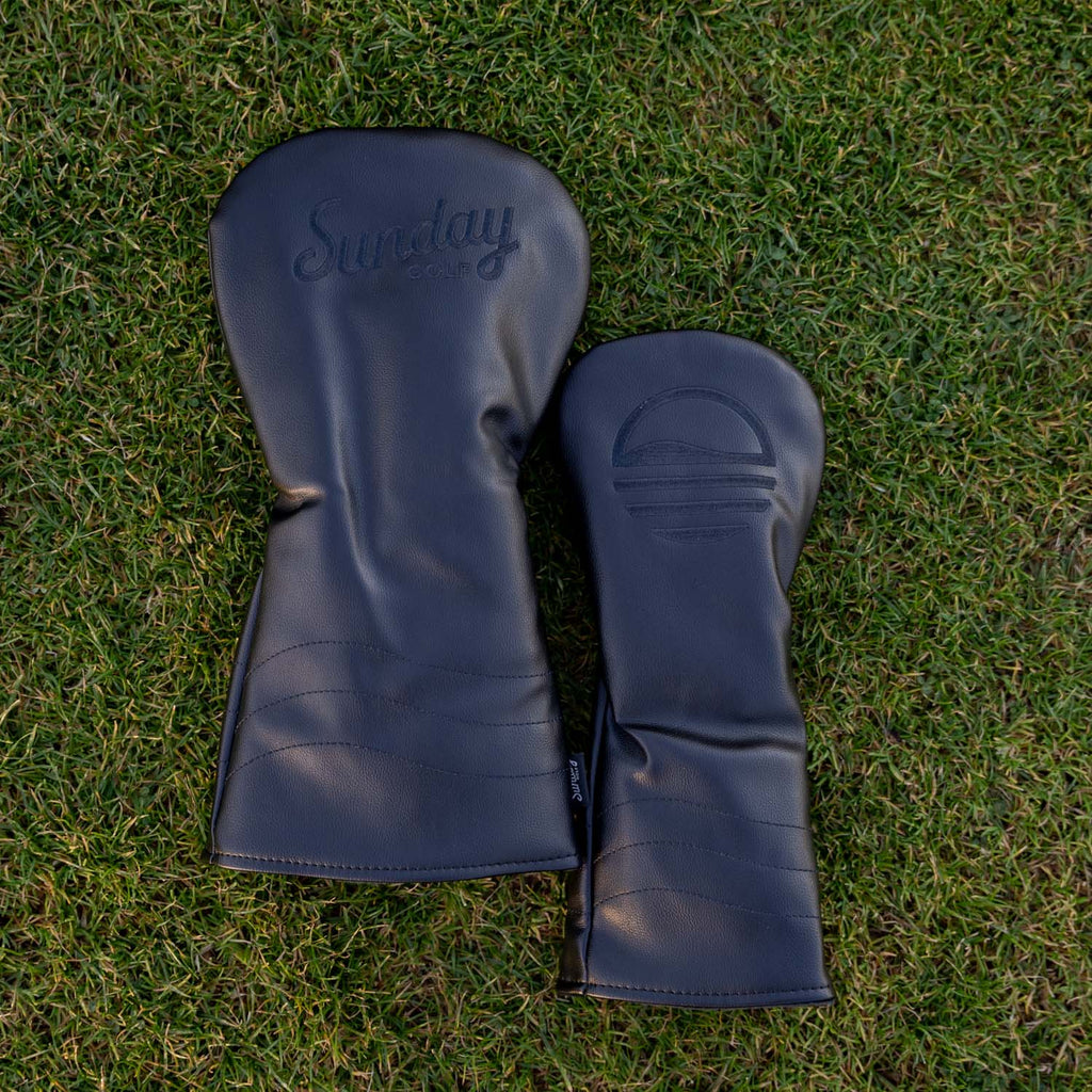 Shots of the driver golf & fairway wood headcover in black vegan leather in the grass