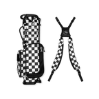 A full shot of a checkered Black & White Recess kids golf bag laying flat sideways beside its double straps