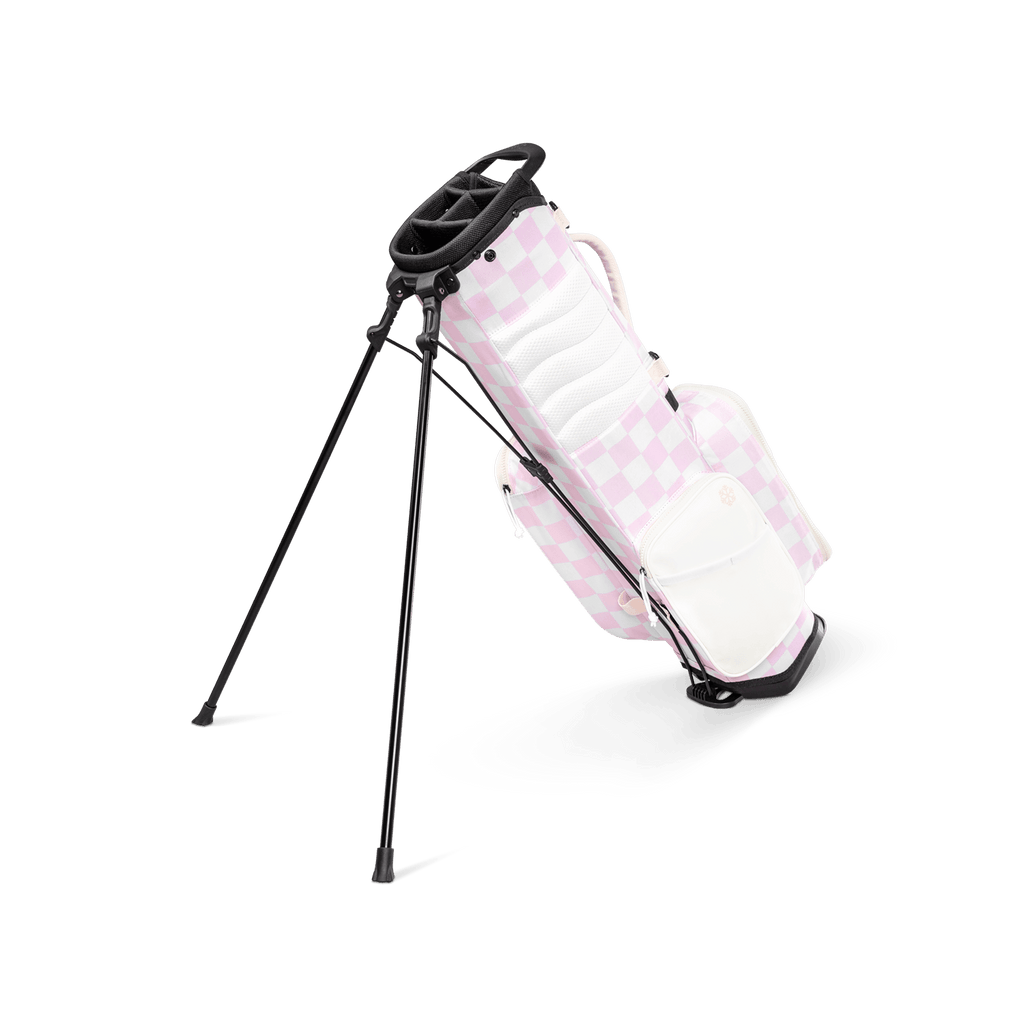 A full shot of a checkered Pink & White Recess kids golf bag facing backward
