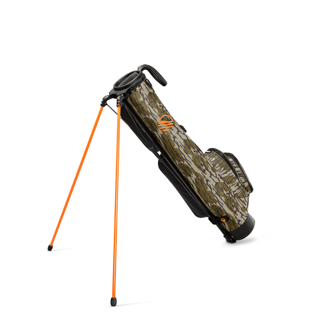 A full shot of standing Loma golf bag in mossy oak bottomland facing backward