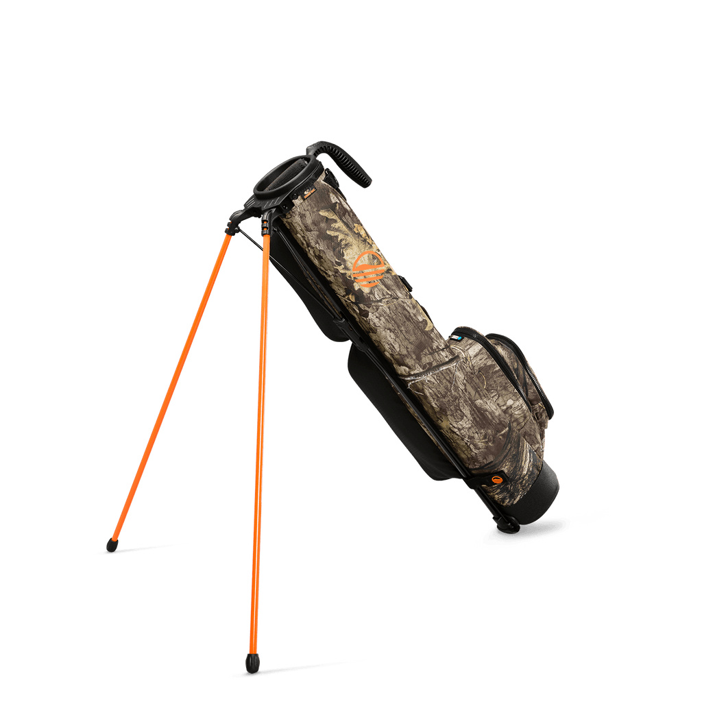 A full shot of standing Loma golf bag in mossy oak country dna facing backward