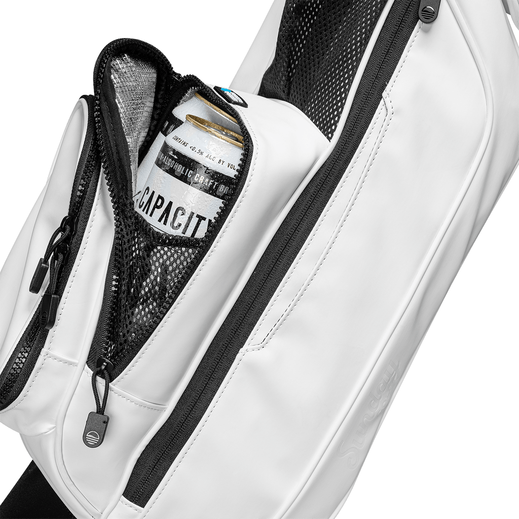 A close up shot of white vegan leather Loma S-Class golf bag's frosty pocket with a canned drink inside