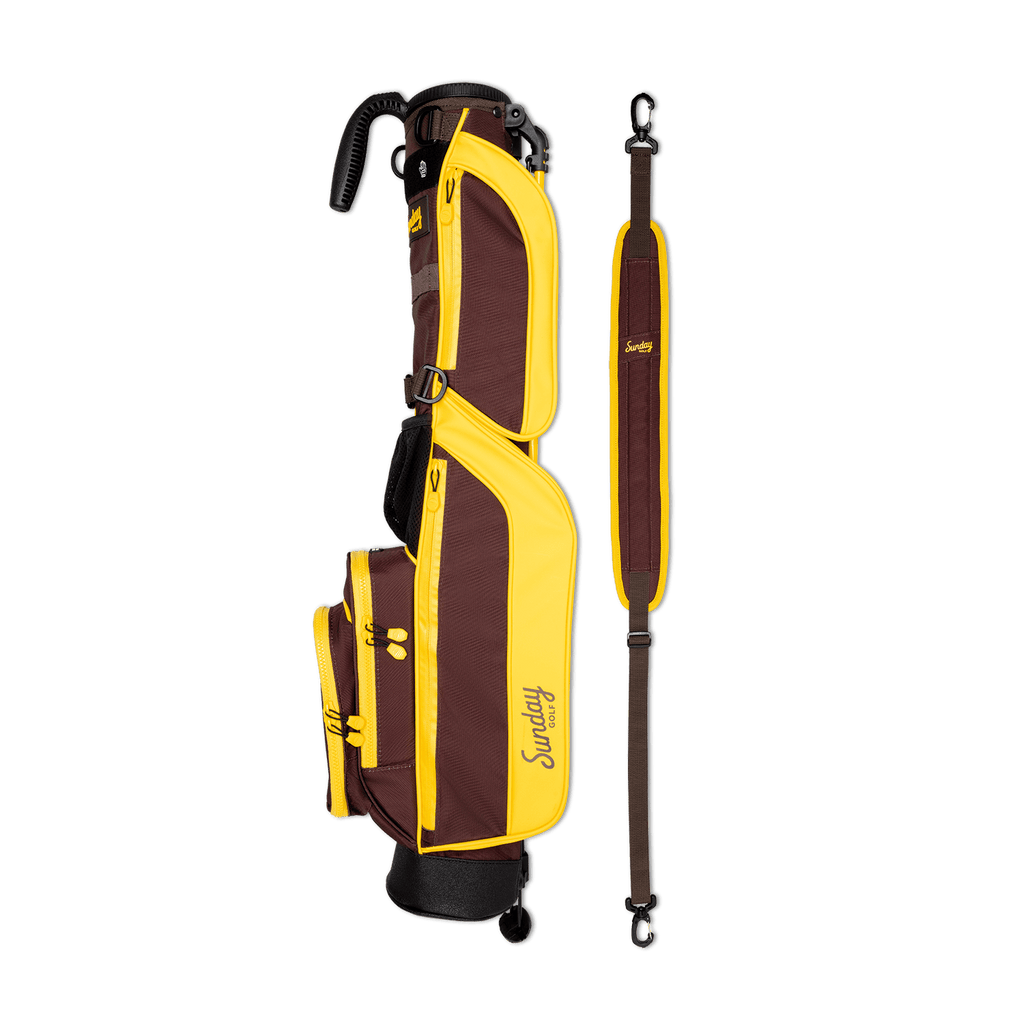 A full shot of Loma golf bag in Friars Brown laying flat sideways beside its single strap

