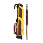 A full shot of Loma golf bag in Friars Brown laying flat sideways beside its single strap
