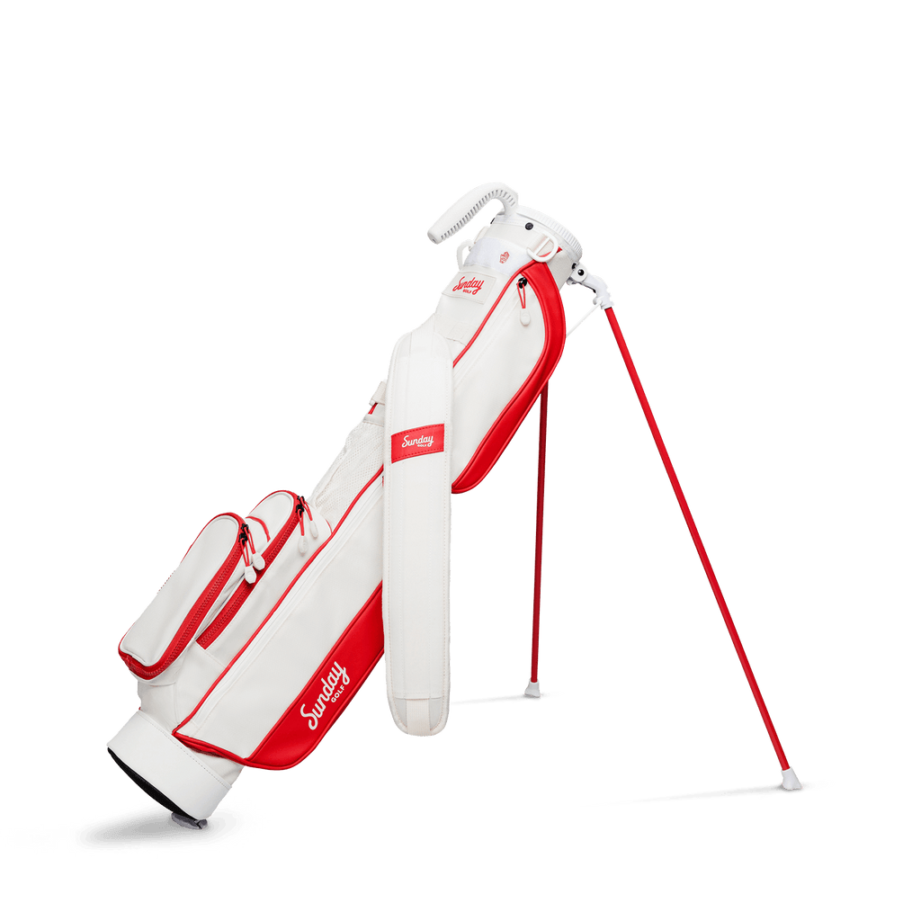 A full front shot of standing Loma golf bag in red & off-white with single strap