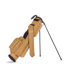 Tan golf bag with a black golf club on a white background