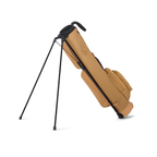 Tan golf bag with black stand on a white background