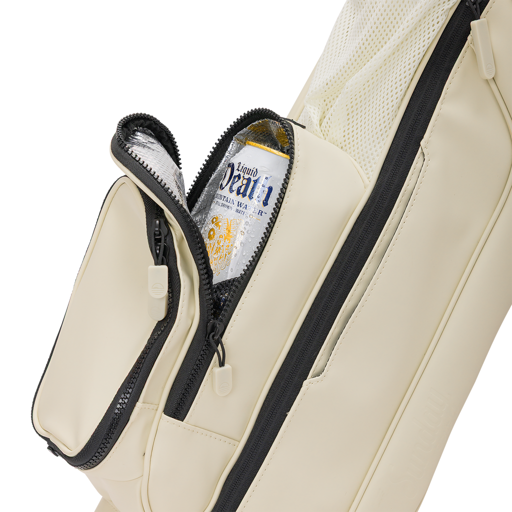 A close up shot of Cream Loma S-Class golf bag's insulated pocket with a canned drink inside
